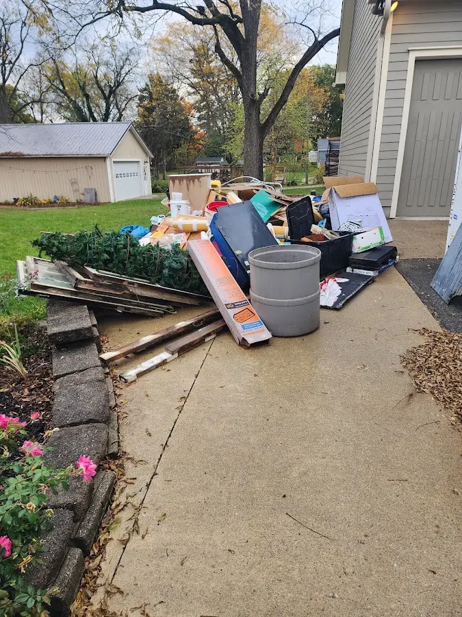 Dumpster being loaded with debris for 12 Yard Dumpster Rental in West Vincent